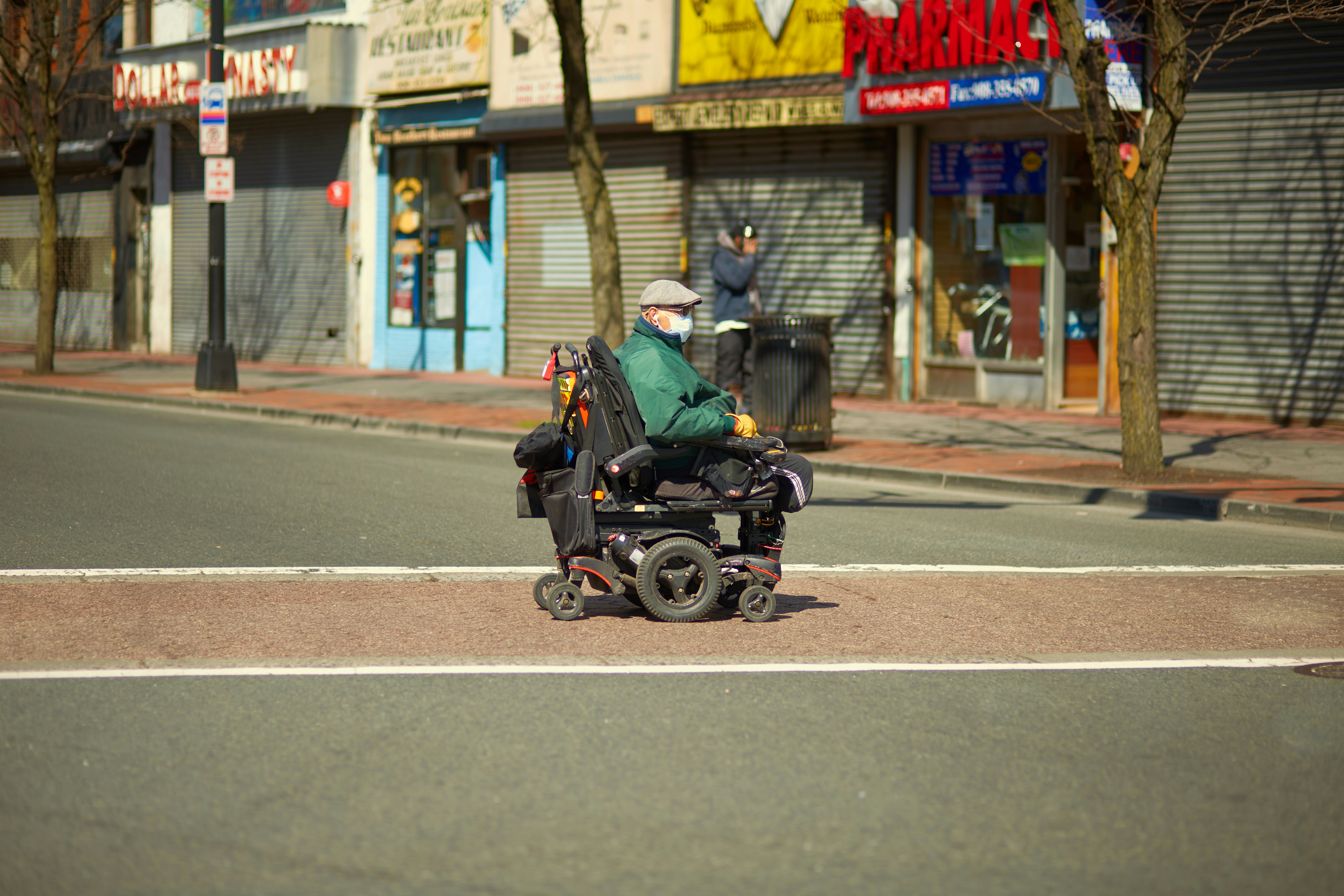 Senior using mobility aid on a NYC street, smiling and independent